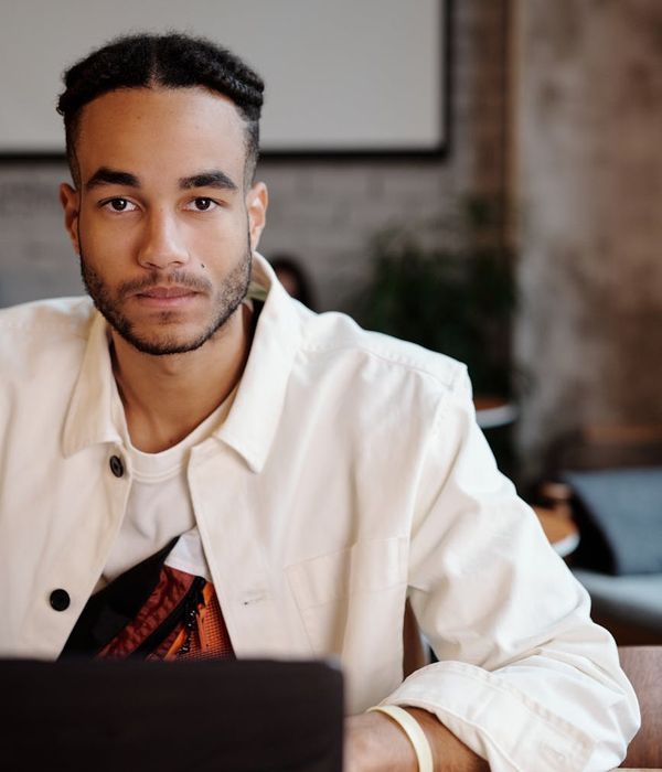 Person working at a desk looking relaxed and focused.